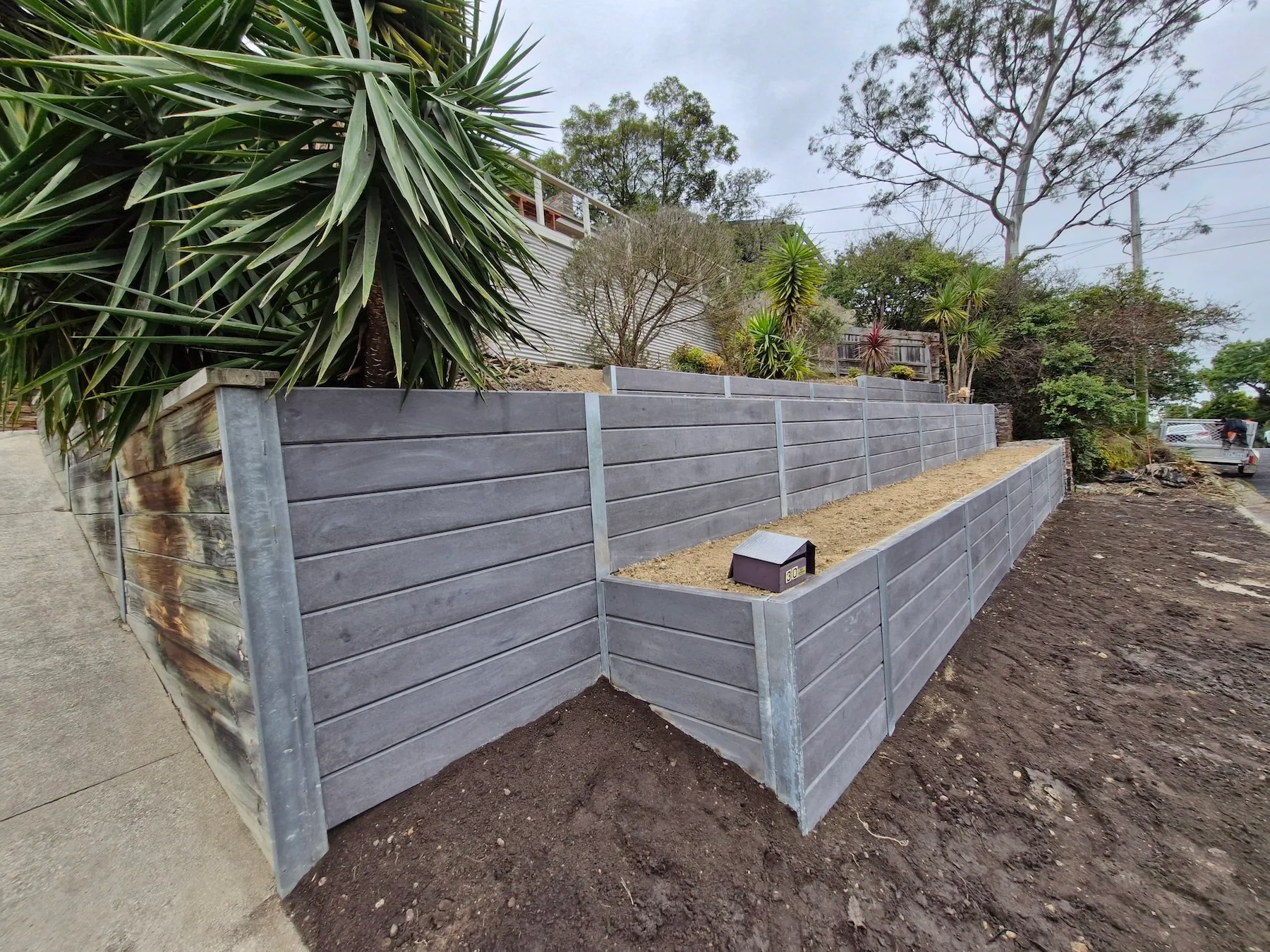 Concrete sleeper retaining wall in a Melbourne garden